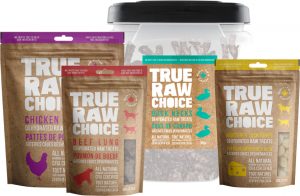 A selection of True Raw Choice natural dehydrated treats including beef lung, chicken feet, duck necks, and Monterey Jack cheese puffs.